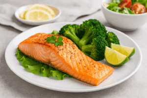 Grilled salmon served with steamed broccoli and lime as one of the best foods for weight loss due to its omega-3 content