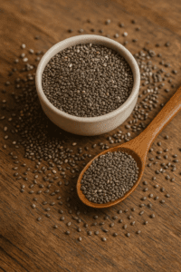  Chia seeds in a glass jar on a wooden table, showcasing their fiber-rich and omega-3-packed benefits as a natural aid for satiety and fat burning.